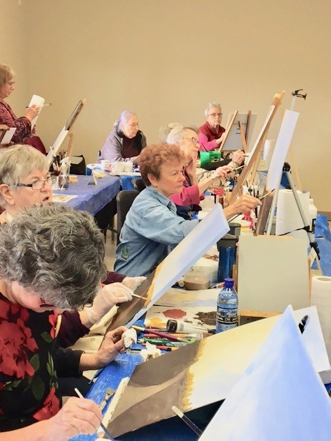 Art class with community members painting together